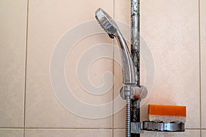 Hard water deposit and rust on shower tap