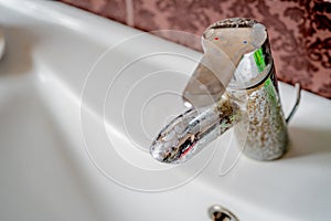 Hard water deposit on a tap