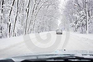 Hard winter traffic with car on snow coverd road