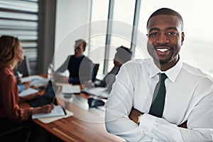 Hard work and determination are the basic ingredients of success. Portrait of a confident businessman standing in an