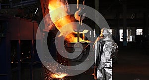 Hard work in the foundry. Pouring molten steel. Liquid steel pouring.