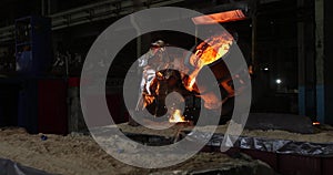 Hard work in the foundry. Pouring molten steel. Liquid steel pouring.