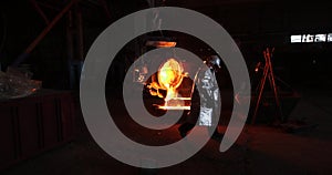 Hard work in the foundry. Pouring molten steel. Liquid steel pouring.