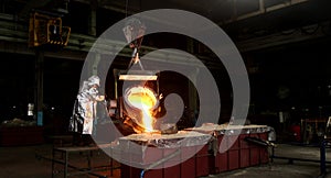 Hard work in the foundry. Pouring molten steel. Liquid steel pouring.