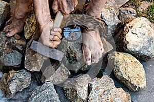 Hard work. Hands holding a hammer. The desire to free oneself