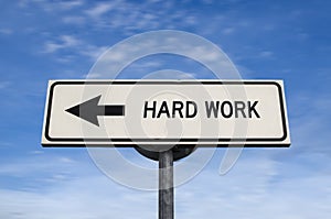 Hard work road sign, arrow on blue sky background