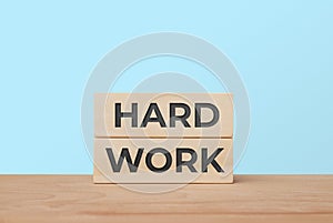 Hard work success concept with stacked wooden blocks
