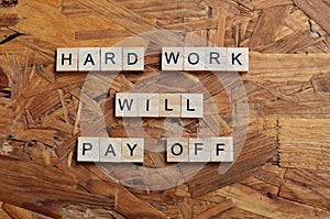 hard work will pay off text on wooden square, motivation quotes.