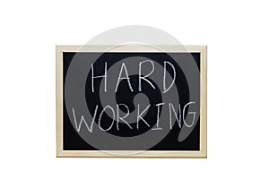 HARD WORKING written with white chalk on blackboard