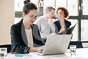 Hard-working young woman analyzing business information