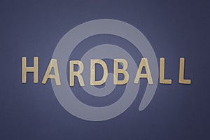Hardball written with wooden letters on a blue background photo