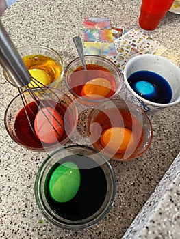 hardboiled eggs in colorful bright dye cups for EASTER EGGS, Easter bunny