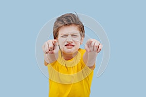 Hardcore boy pointing at camera, in yellow t-shirt