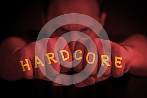HARDCORE written on an angry manâ€™s fists