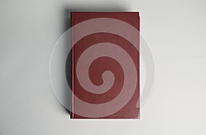 Hardcover book on grey background. Space for design