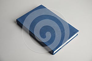 Hardcover book on grey background. Space for design