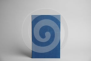 Hardcover book on grey background. Space for design
