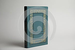 Hardcover book on light grey background. Space for design