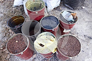 hardened crumb rubber in cans to cover the sidewalks