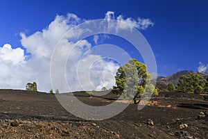 Hardened lava of the volcano on the background of blue sky.