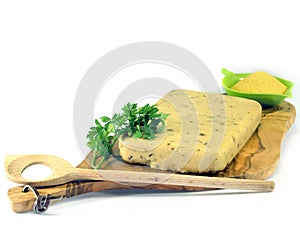 Hardened polenta on wooden olive chopping board