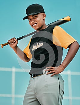 The harder you work, the harder it is to lose. a young baseball player holding a baseball bat while posing outside on