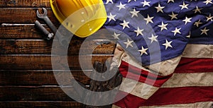 Hardhat, gloves, and tools on US American flag. Strong American workforce or industry, or America labor day