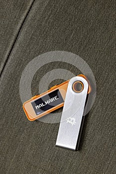 hardware Bitcoin wallet in with Malware message on screen