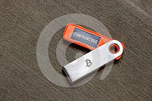 hardware Bitcoin wallet with message Compromised on screen