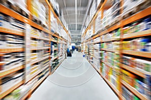 Hardware construction supermarket aisle and shelves. Perspective view of hypermarket rows with products. Blurred