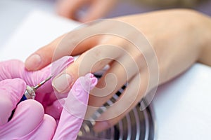 Hardware Manicure using electric device machine. procedure for the preparation of nails before applying nail polish. Hands of photo