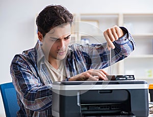 Hardware repairman repairing broken printer fax machine