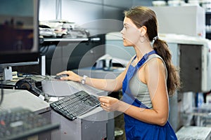 Hardware store employee combining just the right tints of paint in an electronically guided modern mixing machine