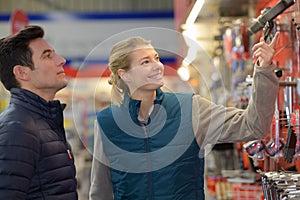 Hardware store worker assisting customer