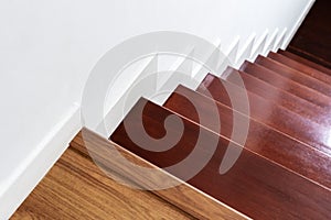 Hardwood stair steps and white wall, interior stairs material and home design photo