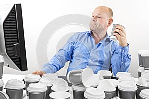 Hardworking business man drinks too much coffee