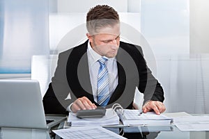 Hardworking businessman analyzing a report