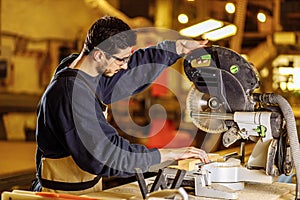 Hardworking carpenter using circular saw