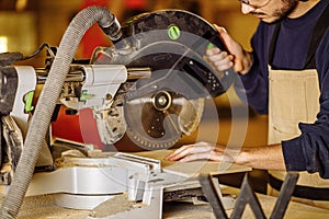 Hardworking carpenter using circular saw