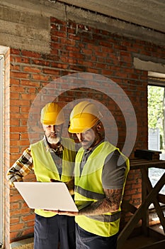 hardworking construction workers in safety vests