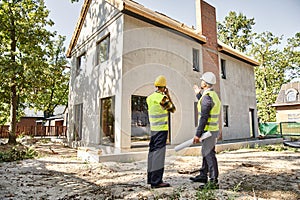 hardworking cottage builder and architect holding