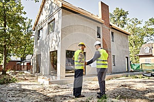 hardworking cottage builder and architect holding