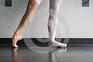 The hardworking disciplined ballerina ballet dancer warming up in her pointe shoes