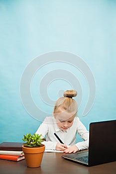 Hardworking elementary student girl homeschooling on laptop online