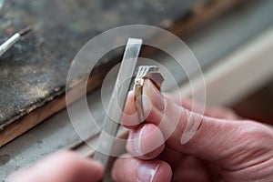 Goldsmith Working On A Unfinished Ring