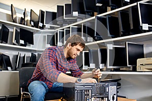 Hardworking guy fixes technical problems with the computer