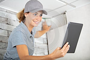 hardworking professional female worker with tablet in workshop