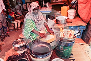 Local Woman making Pita Bread on the Food Market