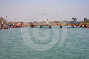 Holy ghats and temples at Haridwar, India, sacred town for Hindu religion. Pilgrims praying and bathing in the Ganges River.