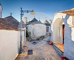 Ð¡harm of the ancient cities of Europe. Splendid morning view of empty strret with trullo trulli